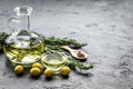 Oil in carafe with spices and olive on stone background mock-up