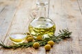 oil in carafe with spices and olive on wooden background mock-up