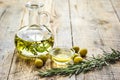 oil in carafe with spices and olive on wooden background mock-up