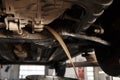 Oil change in automatic transmission. Filling the oil through the hose. Car maintenance station. Red gear oil. The hands