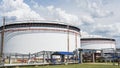 Oil depot storage tanks. Large white Industrial tanks for petrol and oil on sky background. Petrochemical concept