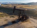 Oil derrick in the desert pumping WTI oil. Royalty Free Stock Photo