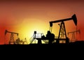 Oil derrick. Pump jack in sunset landscape Royalty Free Stock Photo