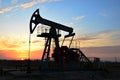 Oil drilling derricks at desert oilfield for fossil fuels output and crude oil production from the ground. Oil drill rig and pump