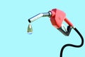 Oil dripping from a gasoline pump isolated on blue background - 3D Rendering.Fuel nozzle with hose fuel pump.Gas pump with drop of