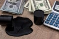 Oil drums on US dollars with calculator Royalty Free Stock Photo