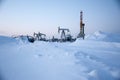 Oil field. Drilling rig and oil pump.