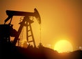 Oil field over sunset. Vector illustration. Gas industry. Dark silhouette drilling rig. Royalty Free Stock Photo