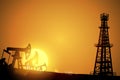 Oil field over sunset. Vector illustration. Gas industry. Dark silhouette drilling rig.