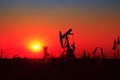 The evening of beam pumping unit in silhouette Royalty Free Stock Photo