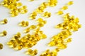 Oil filled capsules, softgel of food supplements. Vitamin D3. Yellow softgels, top view, copy space. Nutritional Royalty Free Stock Photo