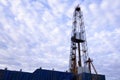 Oil and Gas Drilling Rig onshore dessert with dramatic cloudscape. Oil drilling rig operation on the oil platform in oil and gas