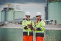 Oil and Gas Engineers Using Tablet for Site Communication and Project Coordination Royalty Free Stock Photo