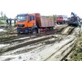 stuck truck in mud on a dirt road.