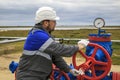 Oil, gas industry. Group wellheads and valve armature, gas production process, Gaz operator, The operator anneals the gas well Royalty Free Stock Photo