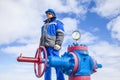 Oil, gas industry. The mechanic - the repairman, gas production operator opens the valve, gas equipment and fitting at the well