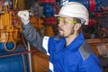 Oil, gas industry. The mechanic - the repairman, gas production operator opens the valve, gas equipment and fitting, toned