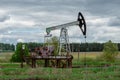 Oil and gas industry. Silhouette oil pumps on a sunset sky background. Toned