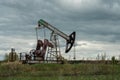 Oil and gas industry. Silhouette oil pumps on a sunset sky background. Toned.