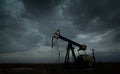 Oil and gas rig profiled on storm clouds Royalty Free Stock Photo