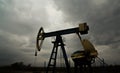 Oil and gas rig profiled on storm clouds Royalty Free Stock Photo