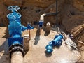 Oil, gas, water industry. Wellhead with valve armature underground. Dug deep trench Royalty Free Stock Photo