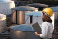 Female engineer wearing safety helmet in oil and gas industry field