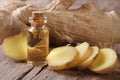 Oil of ginger in a small glass bottle macro and root