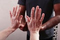 Oil on the hands of massage therapists. Preparation for massage.Massage in four hands. Hands close-up. Male and female