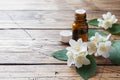 Oil of jasmine. Aromatherapy with jasmine oil. Jasmine flowers. Wooden background with copy space