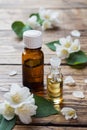 Oil of jasmine. Aromatherapy with jasmine oil. Jasmine flowers. Wooden background with copy space