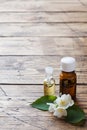 Oil of jasmine. Aromatherapy with jasmine oil. Jasmine flowers. Wooden background with copy space