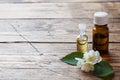 Oil of jasmine. Aromatherapy with jasmine oil. Jasmine flowers. Wooden background with copy space