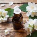 Oil of jasmine. Aromatherapy with jasmine oil. Jasmine flowers. Wooden background with copy space