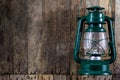 Oil lamp hung on a wooden wall. An old method of lighting rooms. Royalty Free Stock Photo