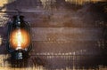 Oil lamp at night on a wooden wall - old Lantern vintage classic black Royalty Free Stock Photo