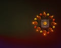 Oil lamps lit on dark background wit circular formation and copy space, Diwali backgrounds , clay oil lamps