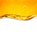 Oil liquid with bubbles. Golden wave on white background Royalty Free Stock Photo