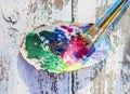 Oil paints and brushes on the old wooden table Royalty Free Stock Photo