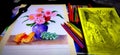 Oil pastel color drawing for a flower pot with pencils and other pictures around