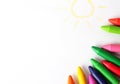 Oil pastel crayons lying on a paper with painted children's draw Royalty Free Stock Photo