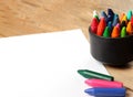 Oil pastel crayons in a mug on a wooden table Royalty Free Stock Photo