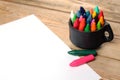 Oil pastel crayons in a mug on a wooden table Royalty Free Stock Photo