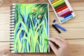 Oil pastels crayons colorful picking art drawing on wood table.