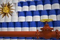 Many barrels with flag of Uruguay and oil pipe. 3d rendering