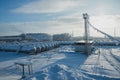 White tanks in tank farm with iron staircase in snow Royalty Free Stock Photo