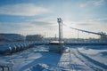 White tanks in tank farm with iron staircase in snow Royalty Free Stock Photo