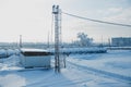 White tanks in tank farm with iron staircase in snow Royalty Free Stock Photo