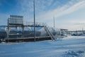 White tanks in tank farm with iron staircase in snow Royalty Free Stock Photo