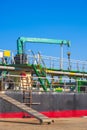 Oil pipeline system with crane machinery in tanker ship during renovation work in shipyard area at harbor Royalty Free Stock Photo